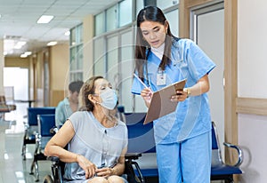 Asian nurse is asking patient for personal information and medical record data for treatment and future care plan option in the