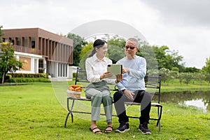 Asian nurse caring for an old man in the garden at home, nurse caregiver supporting health insurance at home