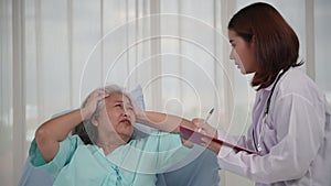 Asian nurse checking up the history of the disease elderly patient lying in bed, Elderly patient care and health lifestyle