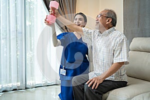 Asian nurse at nursing care support sick senior older man for therapy. Young woman Career Therapist serve physical therapy for