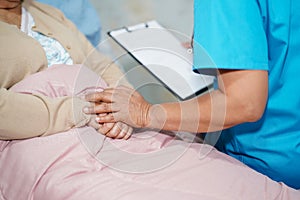 Asian nurse physiotherapist doctor care, help and support senior or elderly old lady woman patient