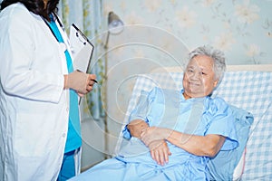 Asian nurse physiotherapist doctor care, help and support senior or elderly old lady woman patient at hospital