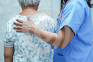 Asian nurse physiotherapist doctor touching Asian senior or elderly old lady woman patient with love, care, helping,