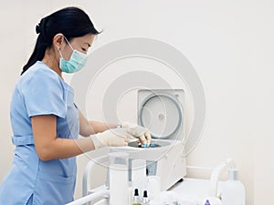 Asian nurse prepare blood separator centrifugal machine to separation