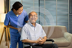 Asian Nurse take care Elderly Senior Man with warm welcome. 70s Mature Man patient has good health and support help by Caregiver