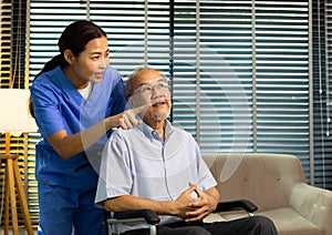 Asian Nurse take care Elderly Senior Man with warm welcome. 70s Mature Man patient has good health and support help by Caregiver