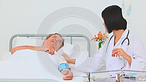 Asian nurse taking the blood pressure of her patient