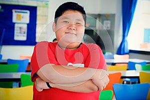 Asian obese boy standing crossed arms
