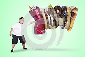 Asian obese man punching unhealthy foods