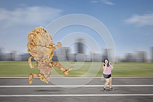 Asian obese woman chased by a fried chicken
