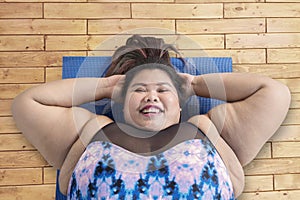 Asian obese woman doing crunches exercise