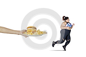 Asian obese woman runs from fast food offered photo