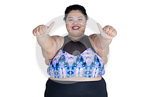 Asian obese woman showing thumbs up on studio