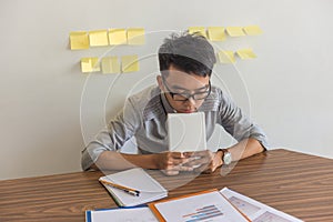 Asian office man worried about bad financial report