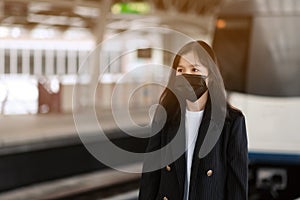 asian office women with face mask in train station