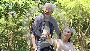 Asian old couple relaxing outdoors in park