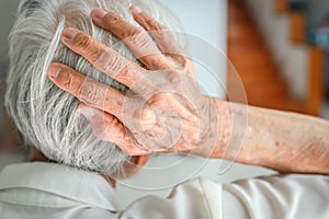 Asian old elderly holding her back of head,emergency headache,painful occurs after a blow to the head,high intracranial pressure, photo