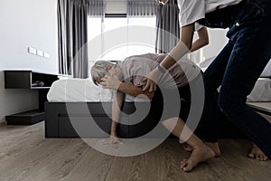 Asian old elderly with vertigo trying to stand up after dizziness loss of balance or staggered symptoms of faint dizzy teen girl