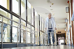 Asian old man walking with a walker in nursing home