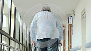 Asian old walking slowly using a walker