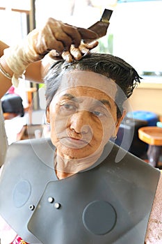 Asian old woman is made color of hair dye.