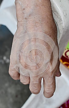 Asian old womanâ€™s hand. Skin creases, loosen skin and veins show aging