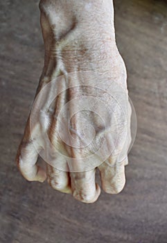 Asian old womanâ€™s hand. Skin creases, loosen skin and veins show aging