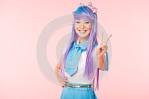 Asian otaku girl showing peace sign isolated on pink