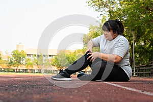 Asian overweight woman a new runner pain ankle during running, Athlete runner training accident. Sport running ankle sprained