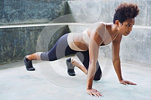 asian pacific islander athlete girl with afro performing exercising routines stretching