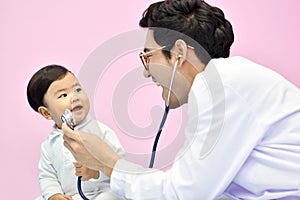 Asian paediatrician examining a baby with a stethoscope