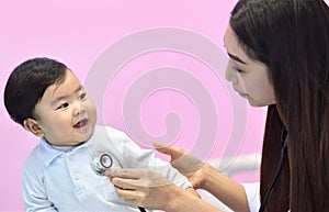 Asian paediatrician examining a baby with a stethoscope photo
