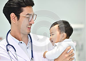 Asian paediatrician is taking care of baby