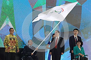 President of Asian Paralympic Committee, Majid Rashed, waving the APC flag in Closing Ceremony Asian Para Games 2018