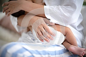 Asian parent hands holding newborn baby fingers, Close up mother`s hand holding their new born baby. Love family healthcare and