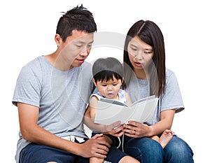 Asian parent reading booking with baby son