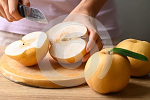 Asian pear or Nashi pear cutting on wooden board