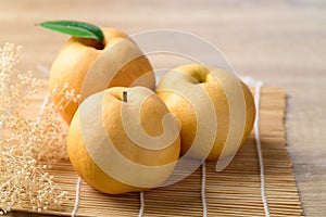 Asian pear or Nashi pear on wooden background
