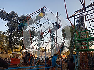 Asian people enjoying swing at village fair events in india January 2020