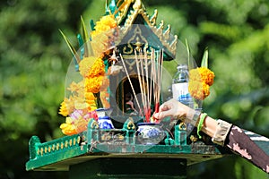 Asian people with incense pay respect to shrine or spirit worship