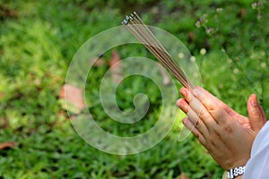 Asian people with incense pay respect to shrine or spirit worship