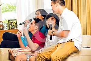 Asian people singing at karaoke party