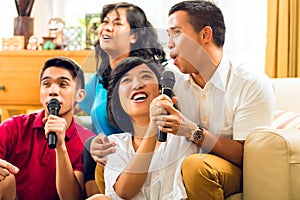 Asian people singing at karaoke party