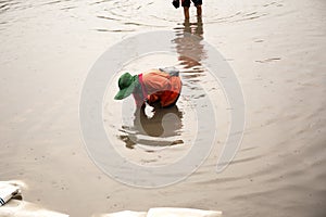 Asian people walking on flooding road during monsoon season