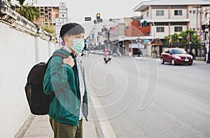 Asian people wearing mask protective gear to protect coronavirus in China and Air pollution pm2.5 concept, backpacker travel