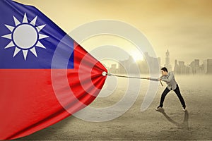 Asian person pulling flag of Taiwan