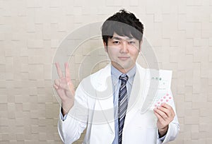 Asian pharmacist gesturing number two