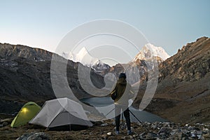 Asian photographer taking a photo of mountain and lake in yading national park