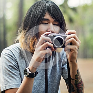 Asian Photographer Taking Pictures Outdoors Concept