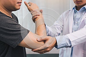 Asian physiotherapists check the elbows of patients who have undergone orthopedic rehabilitation